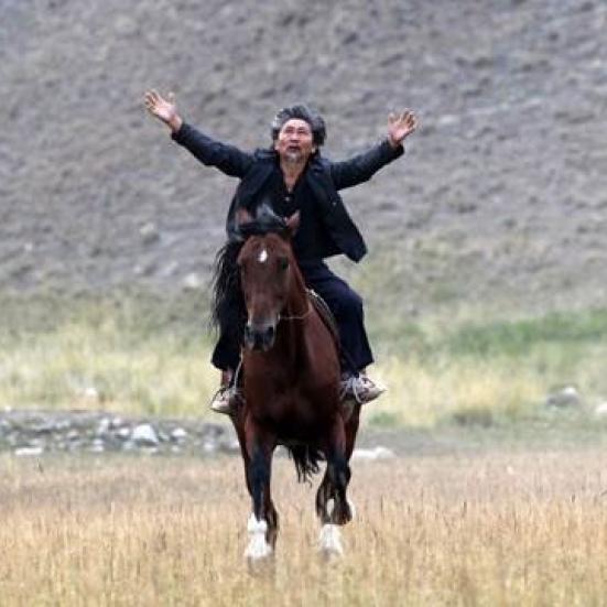 Mand til hest med armene ud til siden